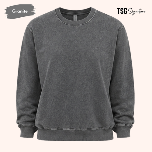 A dark gray mineral-wash crewneck sweatshirt on a light beige background, featuring 'Granite' text in a gray paint brush on the top left and 'TSG Signature' on the top right.