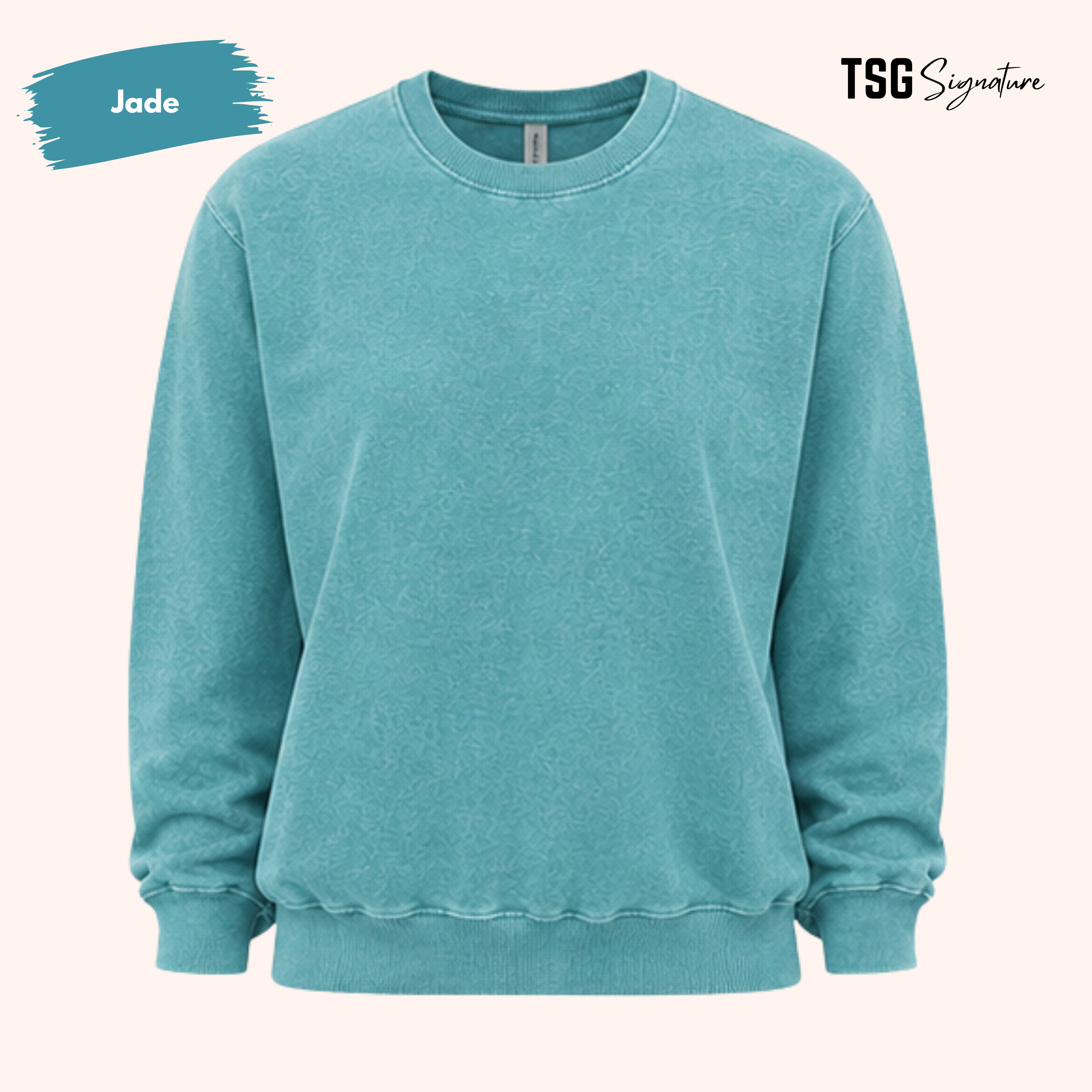 A teal-green crewneck sweatshirt with a washed, faded texture, shown against a light peach background. A blue paint-splatter graphic in the top left corner indicates the color 'Jade', and the 'TSG Signature' brand logo is visible in the top right.